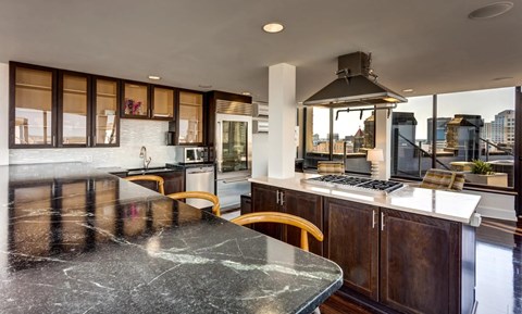 A modern kitchen with a large island and wooden cabinets.