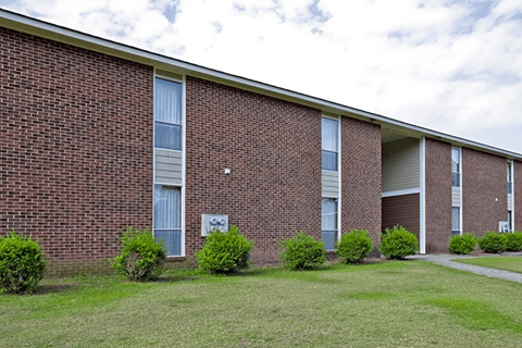 A brick building with a sign on it.