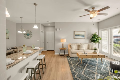 A well-lit, modern kitchen and living room with a dining area.
