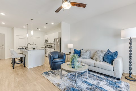 A modern living room with a blue and white rug on the floor.