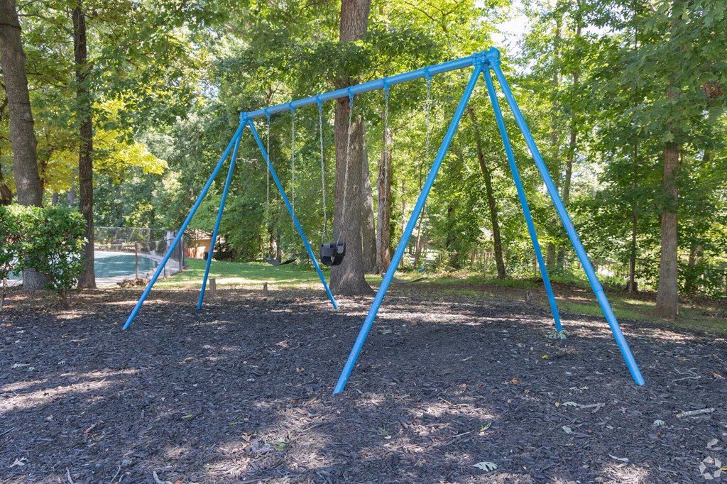 a swing set in a playground in a park