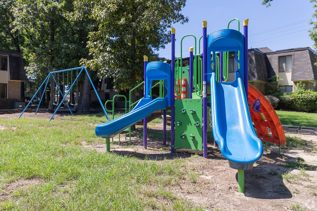 a playground with a slide and other toys in a yard