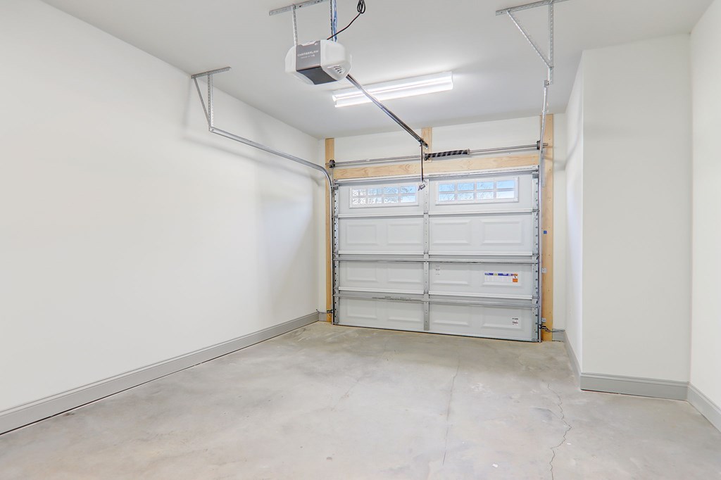 A garage with a white wall and a white door.