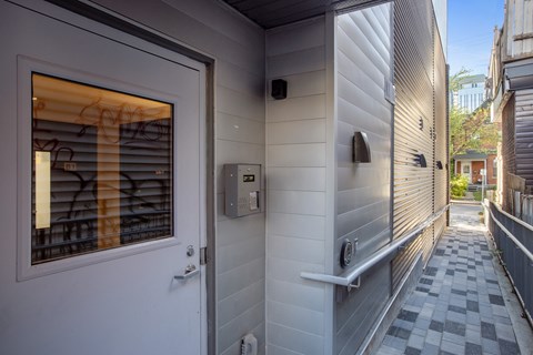 the front door of a house with a walkway and a mailbox