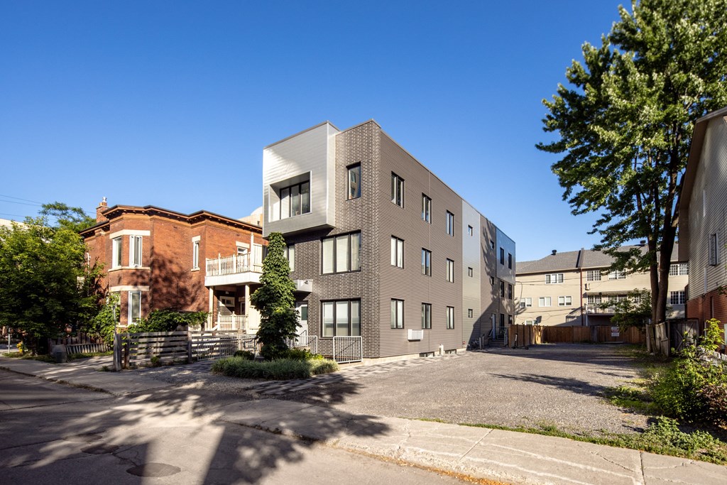 an apartment building with a street in front of it