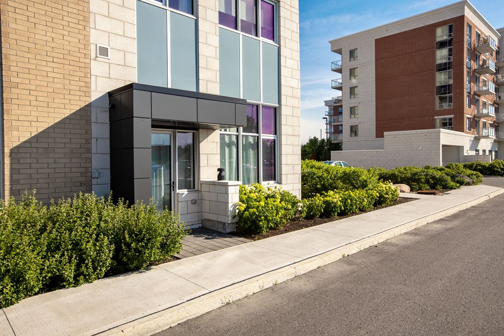 a modern building with a sidewalk in front of it