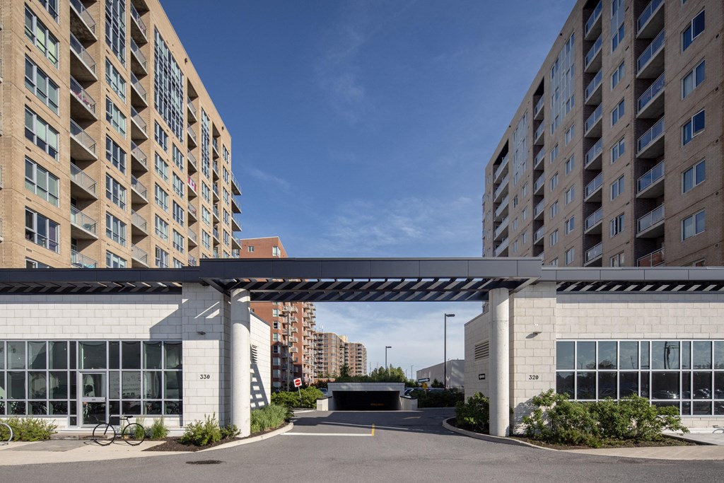 awning over a parking lot between two apartment buildings