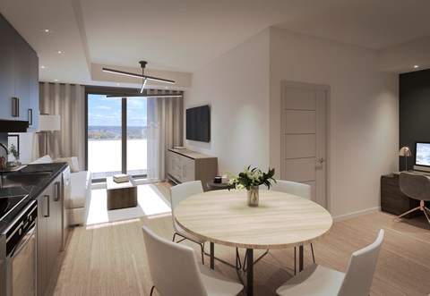 A modern kitchen with a dining table and chairs.
