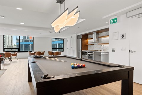 A pool table in a room with a view of the city.