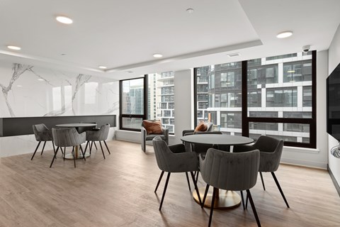 A modern dining room with a large table and chairs.