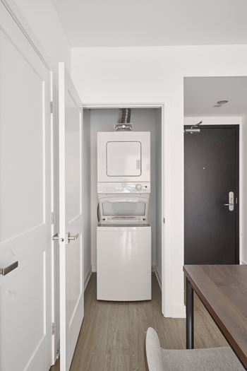 a small room with a refrigerator and a washing machine in it
