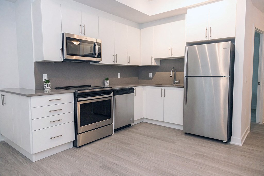 a kitchen with stainless steel appliances and white cabinets