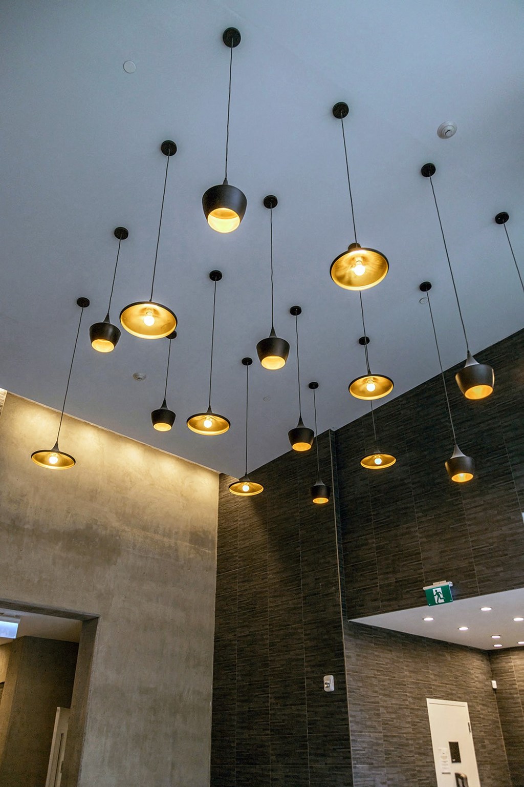 a cluster of lights hanging from the ceiling of a building