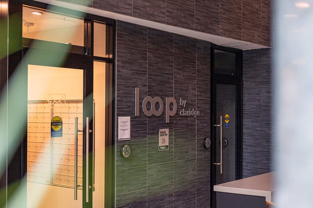 the front door of a building with a sign on it