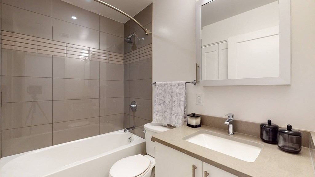 a bathroom with a sink toilet and a bath tub