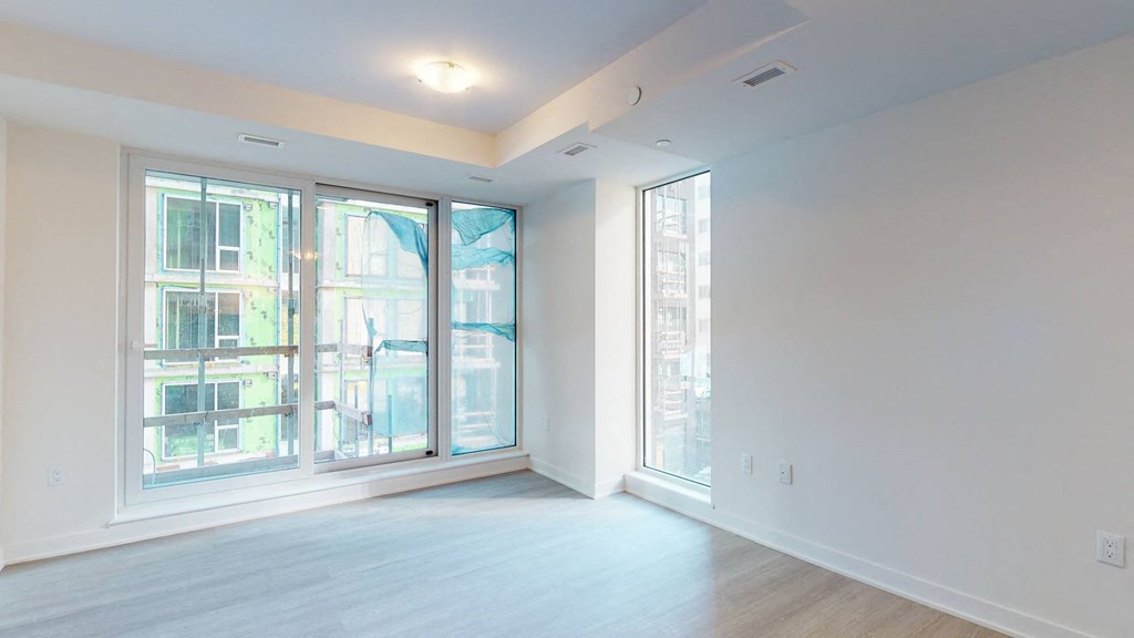 a living room with a large window and white walls