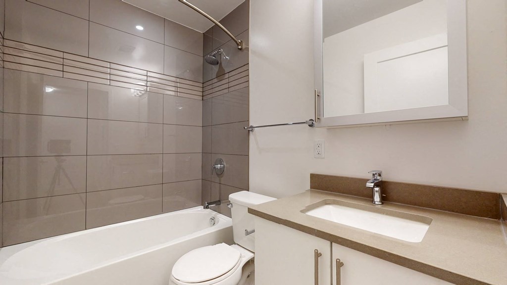 a bathroom with a sink toilet and a bath tub