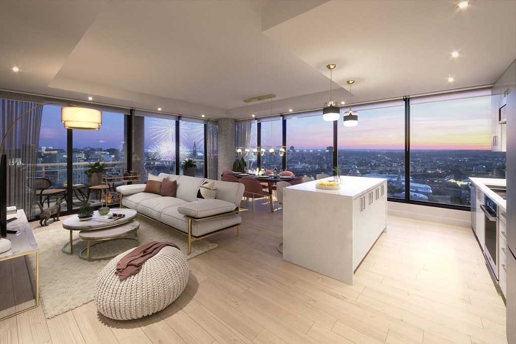 a living room with a kitchen and a view of the city