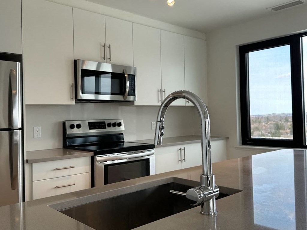 a kitchen with a sink and a microwave