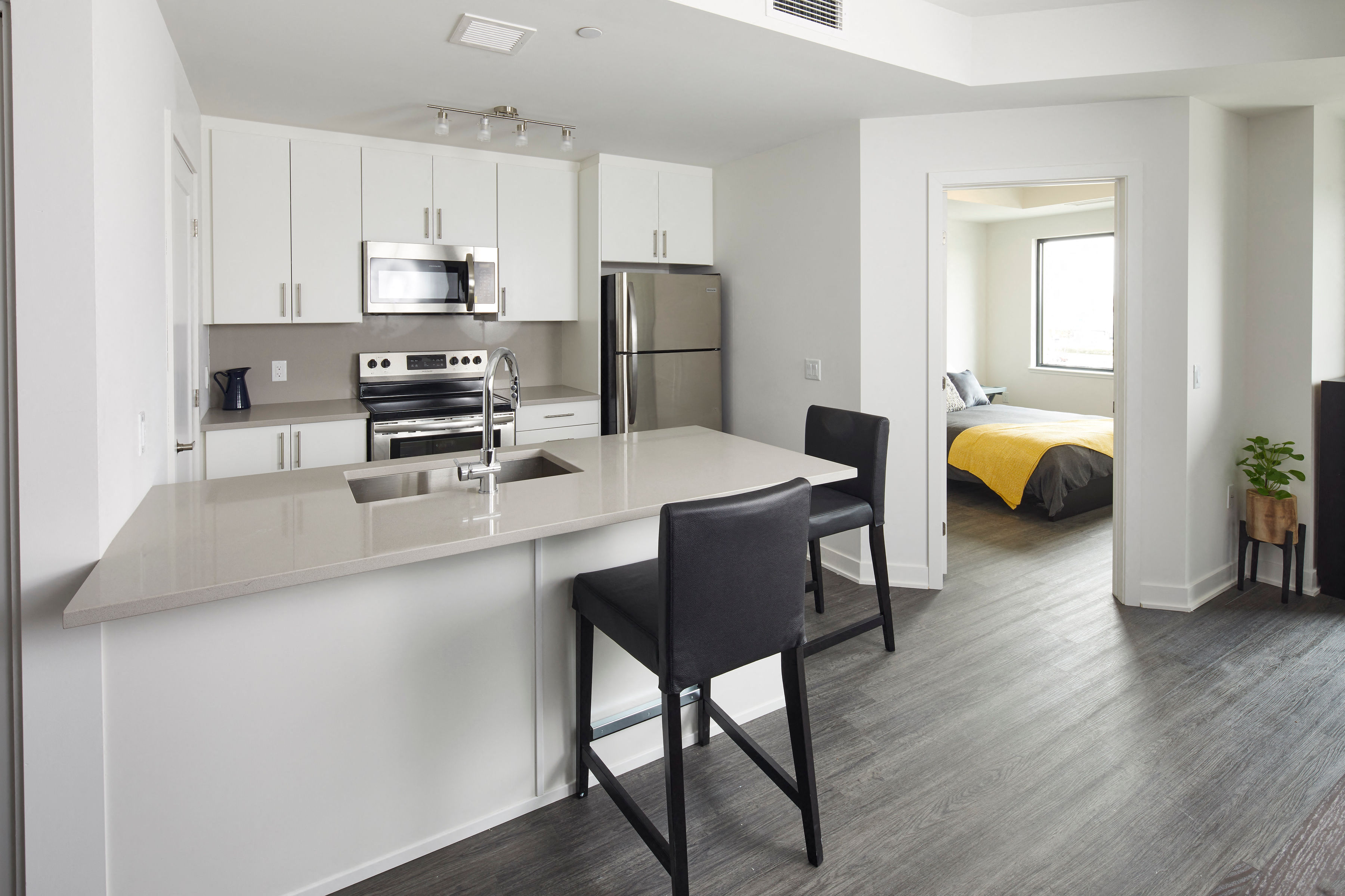 a kitchen and living room with an island and a refrigerator