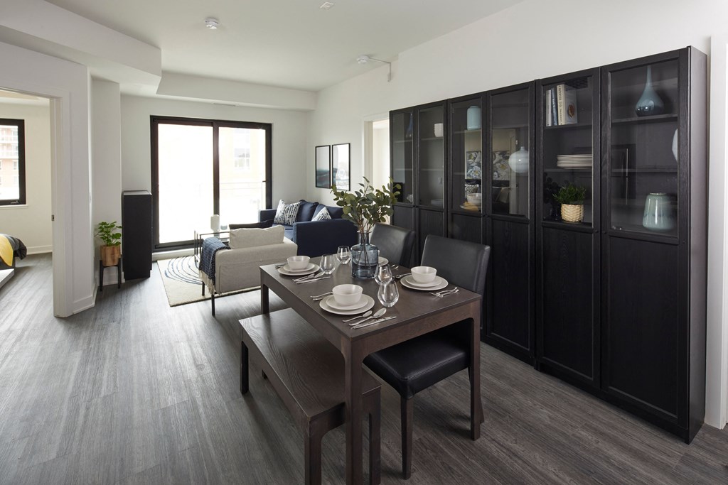 a dining room and living room with a table and chairs