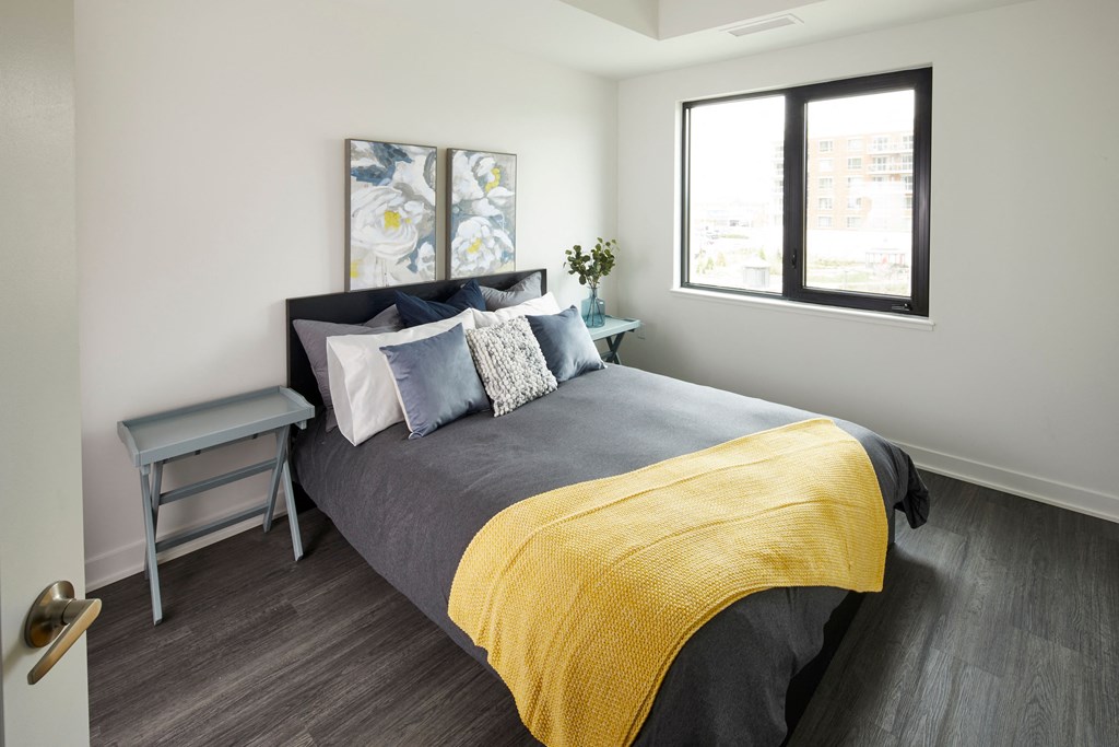 a bedroom with a large bed with a yellow blanket