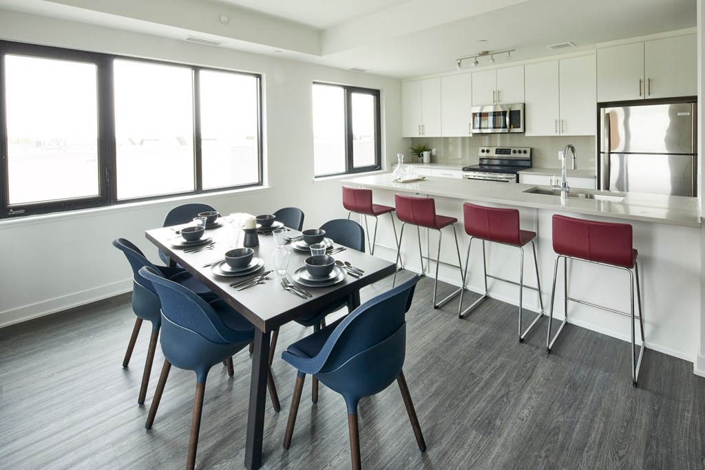 a dining room and kitchen with a table and chairs
