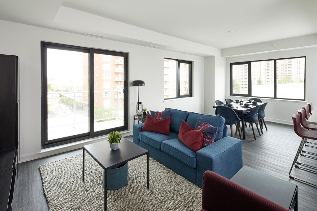 a living room with a blue couch and a coffee table