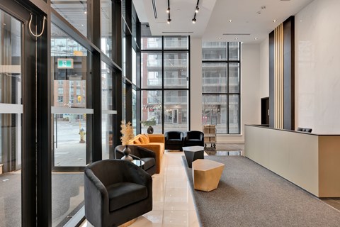 A modern waiting area with black and brown furniture.