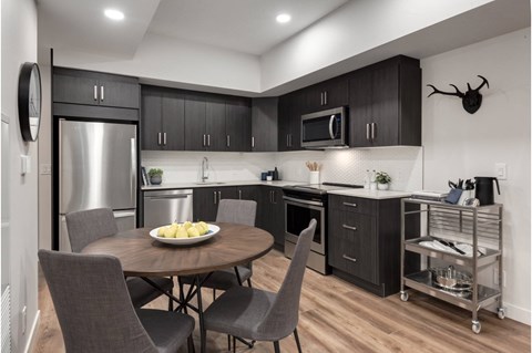 A modern kitchen with a round table and chairs.