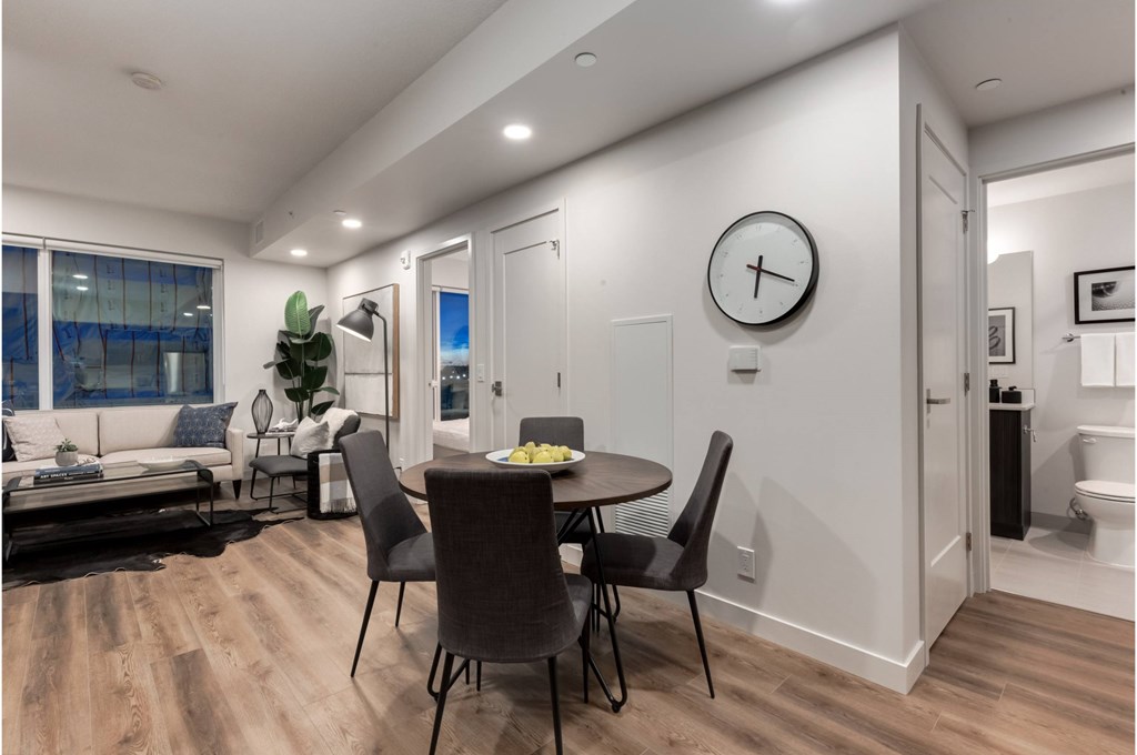 A modern dining room with a round table and chairs.