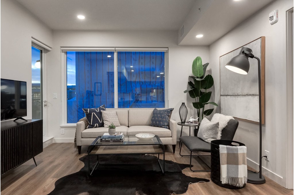 A modern living room with a black and white color scheme.