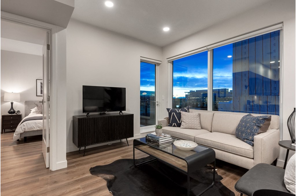 A modern living room with a large window overlooking the city.