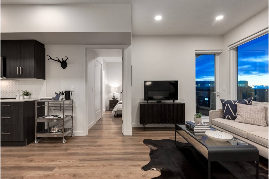 A modern living room with a large window overlooking the city.