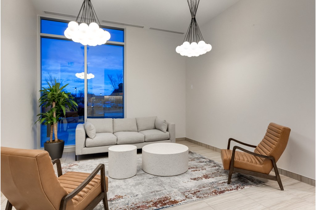 A living room with a couch, chair, and table.