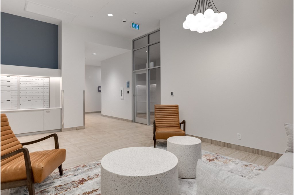 A waiting area with a chair, a table, and a TV.
