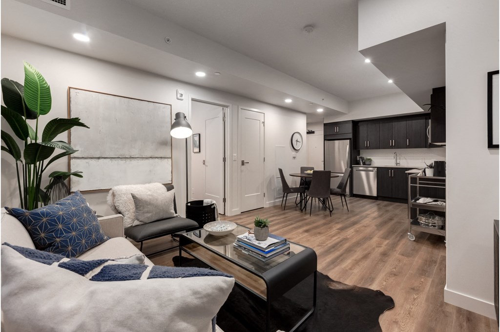 A modern living room with a white couch and a coffee table.