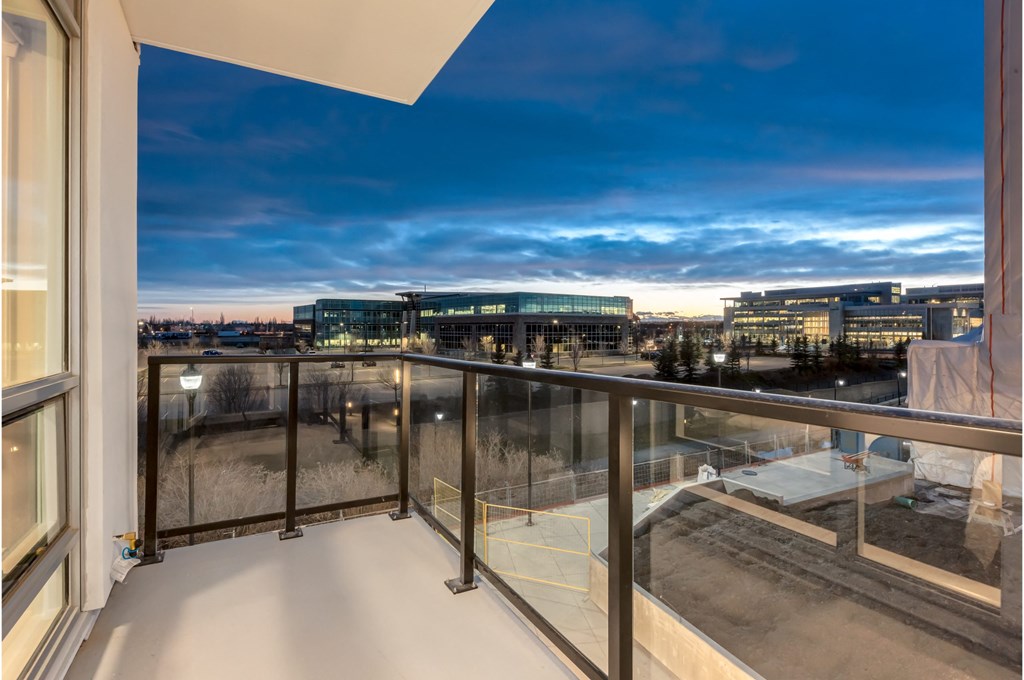 A balcony with a view of a cityscape at dusk.