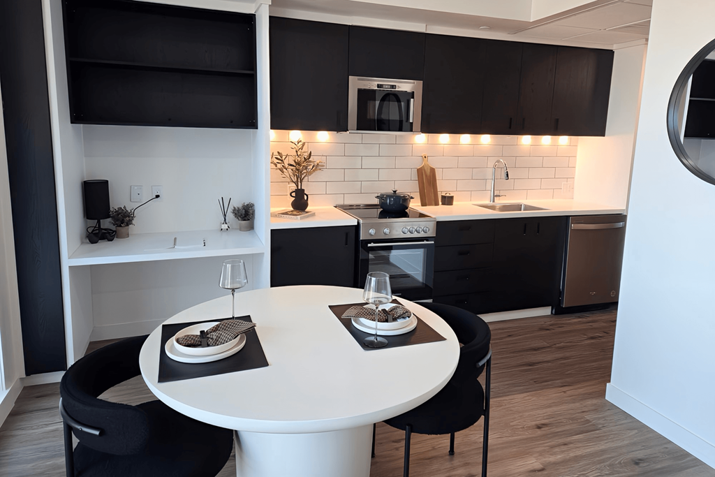 a kitchen and dining area with a table and chairs