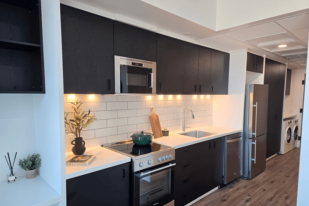 a kitchen with black cabinets and a white counter top