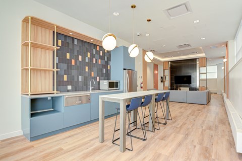 a kitchen with blue cabinets and a long table with chairs
