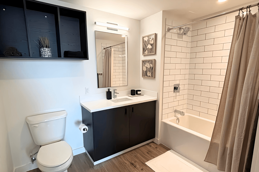 a bathroom with a toilet and a sink and a bath tub