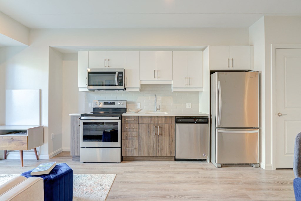 a kitchen with stainless steel appliances and white cabinets