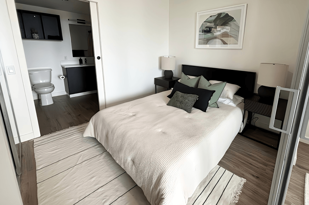 a bedroom with a bed and a bathroom with a toilet