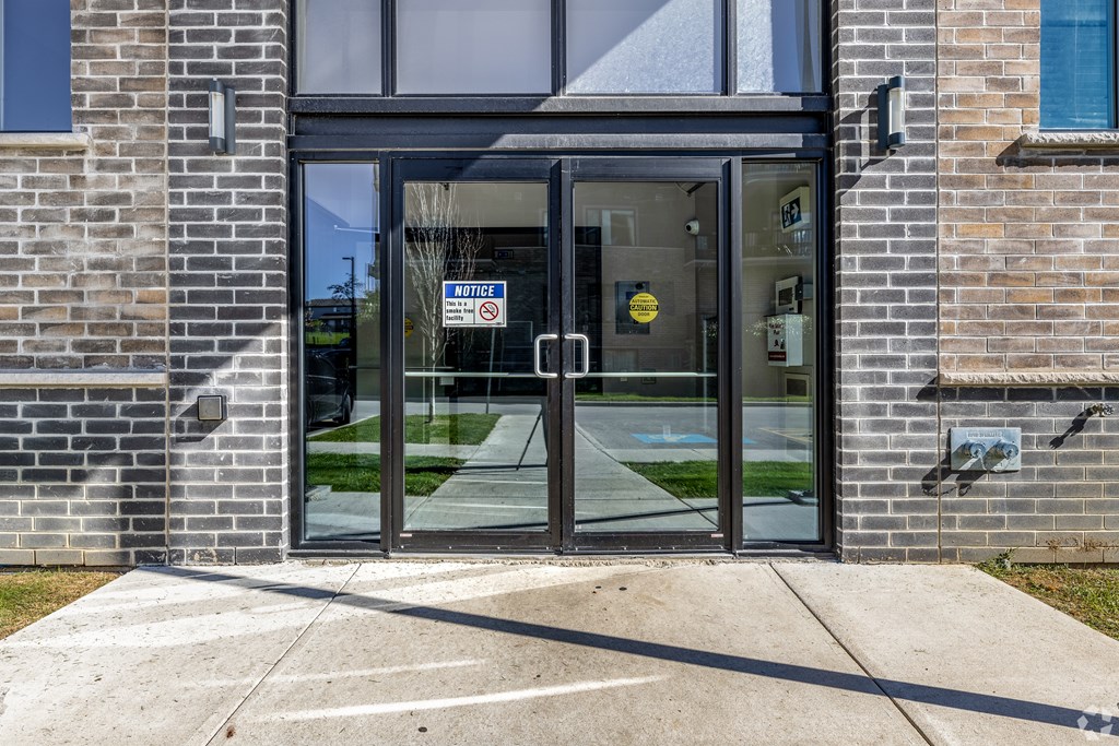 A black glass door with a sign on it.