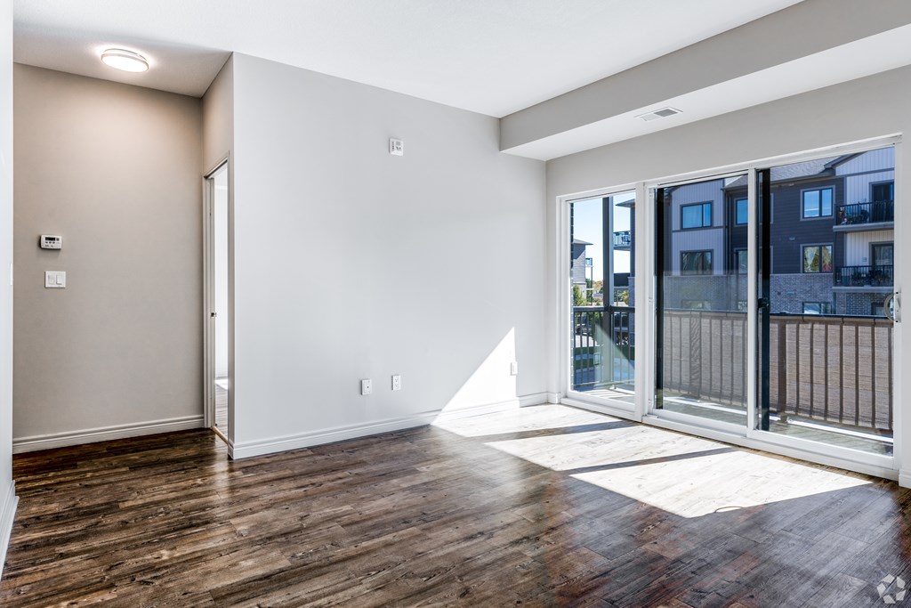 A room with a sliding glass door leading to a balcony.