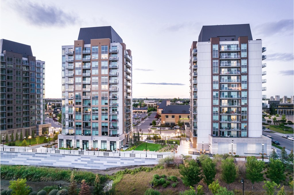 Three modern apartment buildings are shown in the image.