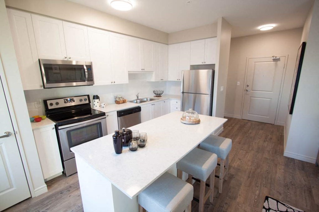 a kitchen with white cabinets and a white counter top