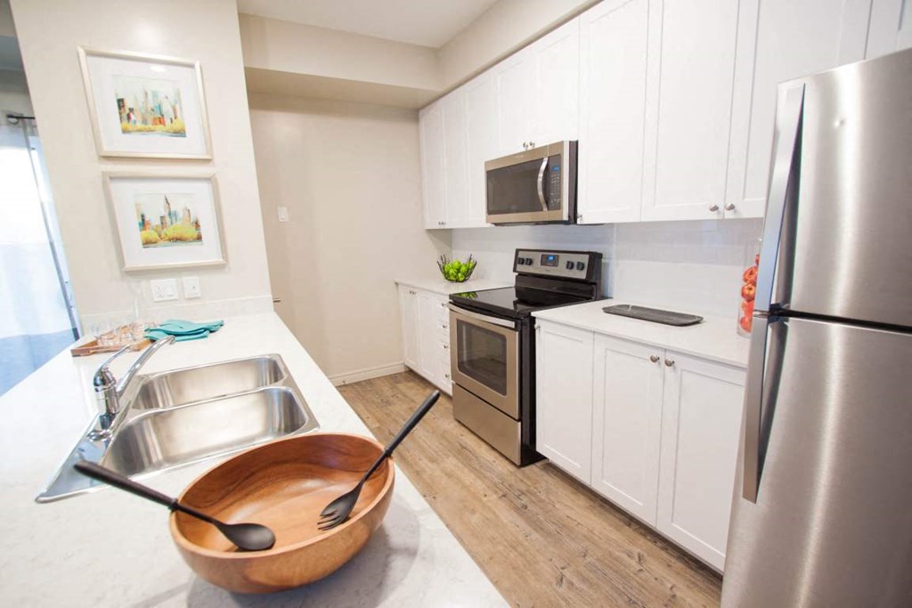 a kitchen with stainless steel appliances and white cabinets