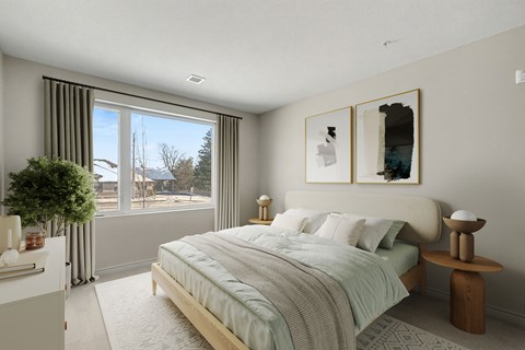 A bedroom with a large bed and a view of the outdoors through the window.